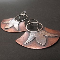 Mixed metal, copper and argentium fan earrings with floral detail. Displayed on black background.