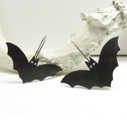 Copper and silver bat earrings. Oxidized to black. Displayed on white antler and background.