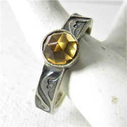A size 7 golden rose cut citrine ring set on a scrolling pattern 5mm wide sterling silver band. Citrine is 6mm. Citrine is the November birthstone, Classic and elegant, ring is oxidized to highlight the pattern.