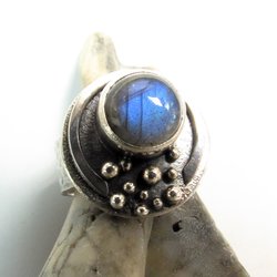 Sterling silver moon ring with large luminous labradorite. Wide hammered band, size 7.75 can be sized up to an 8. Oxidized for depth and drama. large 10mm blue flash labradorite. lots of texture and interesting elements, a celestial statement ring.