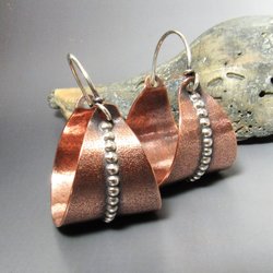 Large basket style hoops in mixed metals of copper and sterling silver to mix and match with your other copper, or silver jewelry.  A strip of beaded silver wire against the sand textured  hoop adds a lovely flourish. 1.33 inch tall x 1 wide.