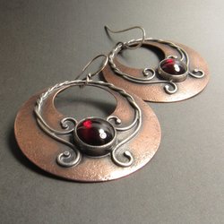 Large gypsy earrings in copper, sterling silver set with large garnets rustic elegance allows them to mix wonderfully with anything of bohemian flavor. Statement earrings that make you standout 2 inch tall x 1.5 wide7.5 grams weight per earring