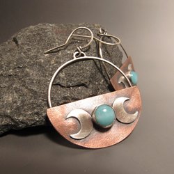 amazonite triple goddess earrings feature the full moon as amazonite and the two crescent moons in sterling silver. The copper half disk sis the lovely background for the amazonite and the silver moons. 2 inches tall with argentium silver ear wires