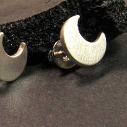 Unisex crescent moon earrings in argentium sterling silver with a matte brushed finish. 1/2 inch wide and finished with sterling silver bullet clutches, a great anytime earring for anyone with pierced ears.