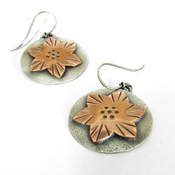 Artisan flower earrings by Mocahete. A layered design with a copper flower on a sterling silver disk. Lightweight at 5 grams each, 1.5 inches tall and 1 inch wide.