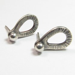 Sterling silver post back or stud earrings shaped like a raindrop and textured. A small orb of silver at the top is the crowning touch. Earrings measure 1/2" long and 1/4" wide. Comes with SS backs not pictured here.Displayed on light background.